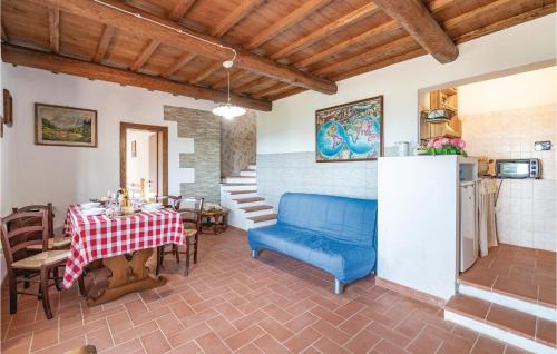 a living room with a table and a blue couch at Casetta 2 in Loro Ciuffenna