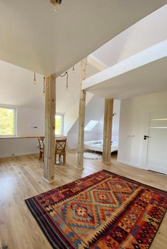 an empty room with a rug on the floor at Apartamenty Osmolice w Stawach in Dęblin