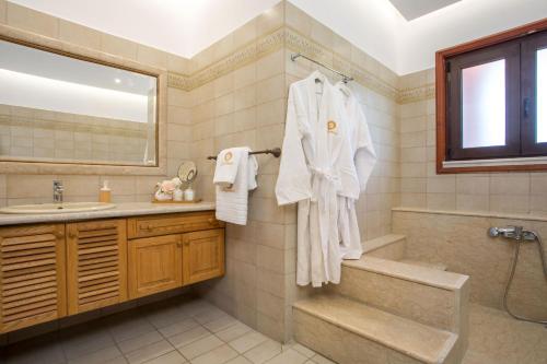 a bathroom with a sink and a shower and a bath tub at Wine & Vineyard Retreat Emarmene in Koskinou