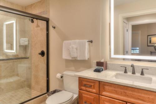a bathroom with a toilet and a sink and a shower at RiverStone Condo Resort & Spa in Pigeon Forge