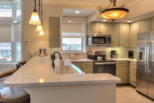 a kitchen with a sink and a refrigerator at RiverStone Condo Resort & Spa in Pigeon Forge