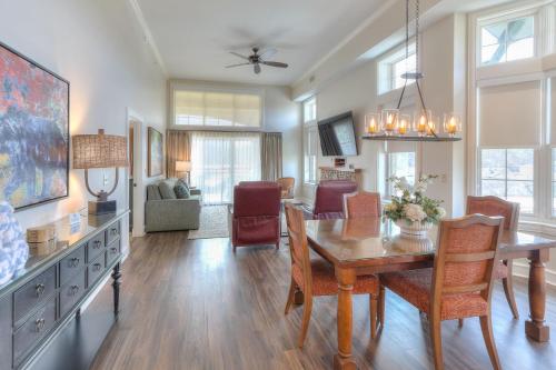 a dining room and living room with a table and chairs at RiverStone Condo Resort & Spa in Pigeon Forge