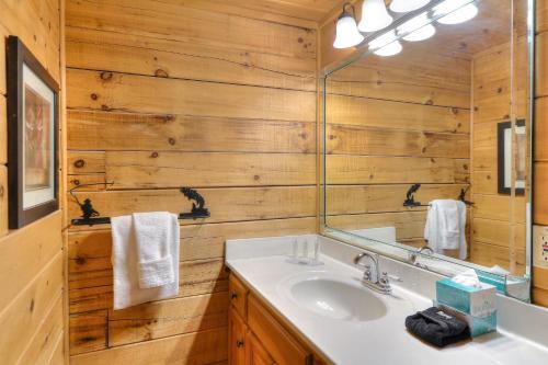 a bathroom with a sink and a mirror at RiverStone Condo Resort & Spa in Pigeon Forge
