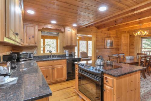 a large kitchen with wooden cabinets and a large island at RiverStone Condo Resort & Spa in Pigeon Forge
