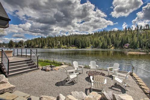 a group of chairs and a table next to a lake at A Contemporary Dream Lakefront Rathdrum Oasis! in Rathdrum