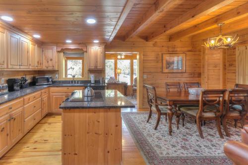 a kitchen with a table and chairs in a cabin at RiverStone Condo Resort & Spa in Pigeon Forge