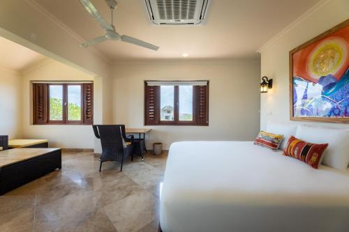 a bedroom with a white bed and a couch at Cliff Villa - Award Winning Luxury Retreat in Westpunt