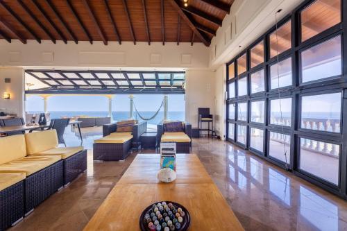 a living room with couches and a table at Cliff Villa - Award Winning Luxury Retreat in Westpunt