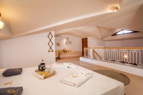 a room with a bed with towels on it at Wine & Vineyard Retreat Emarmene in Koskinou