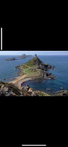 an island in the ocean with a lighthouse on it at Ajaccio magnifique T2 40m2 centre ville vue mer au bord de la plage neuf 5 personnes Clim wifi balcon parking privé fermé in Ajaccio