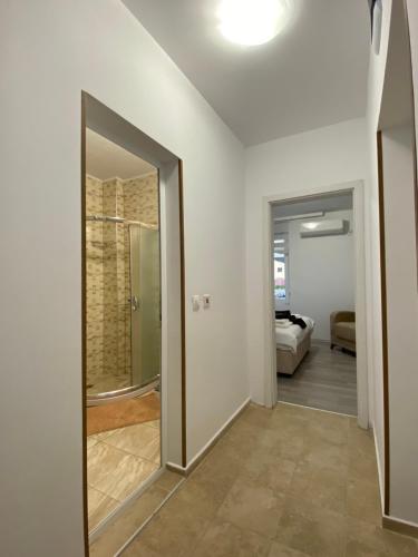 a hallway with a door leading to a bedroom at Апартамент Ели in Obzor