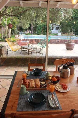 a wooden table with food on top of it at Kapera Maison d'Hotes in Macaye