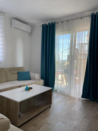 a living room with a couch and a coffee table at Apartman Holiday in Tivat