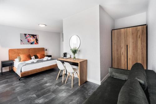a bedroom with a bed and a desk with a mirror at Villa Bluemica in Międzyzdroje