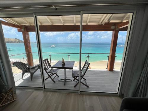 a dining room with a view of the ocean at PARADISE VIEW 1 bed-room water front studio at Grand Case in Grand Case