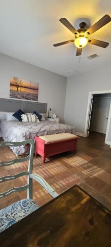 a bedroom with two beds and a ceiling fan at Hill Country Haute n Haus Relax and Renew in Fischer