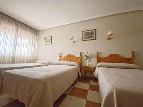 Säng eller sängar i ett rum på Hotel Salvador