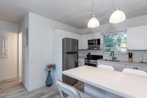a kitchen with a counter top and a refrigerator at Modern Riverview Apartments in Fort Lauderdale
