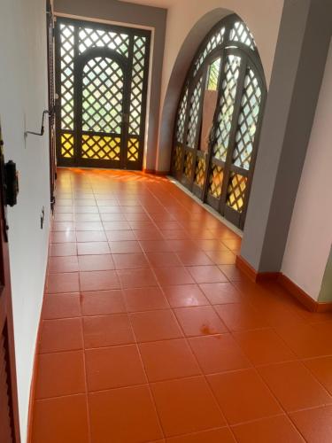 an empty hallway with an orange tiled floor at RedHouse in Crotone