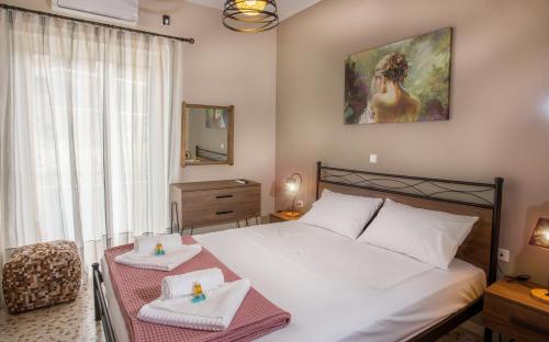 a bedroom with a bed with a table with two towels at 3SSS Bouquet Studios SERENITY in Marmarion