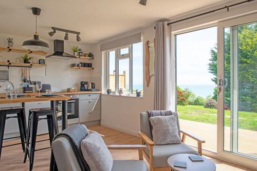 a kitchen and living room with a large window at The Jolly Lodge-Sea Views-Free Parking in Lyme Regis