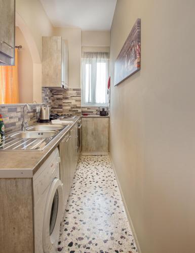 a kitchen with a sink and a washing machine at 3SSS Bouquet Studios SERENITY in Marmarion