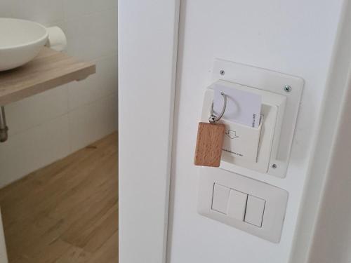 a padlock on the door of a white refrigerator at SINFONIA SUITES CATANIA in Catania