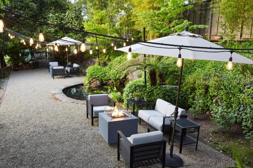 a patio with tables and chairs and an umbrella at Milliken Creek Inn in Napa