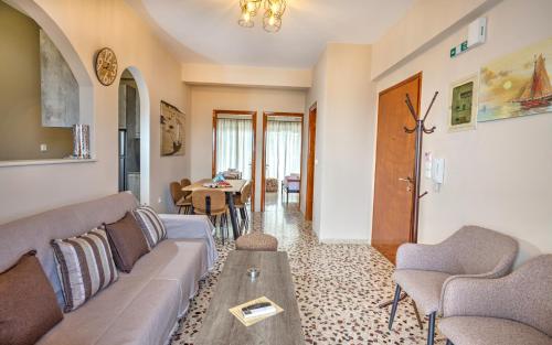 a living room with a couch and a table at 3SSS Bouquet Studios SERENITY in Marmari