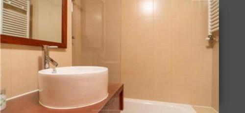 a bathroom with a sink and a bath tub at Bonito holiday, La Torre Golf Resort in Murcia
