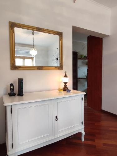 a white dresser with a mirror on top of it at Deluxe Apartment Lejla - Free garage parking in Sarajevo