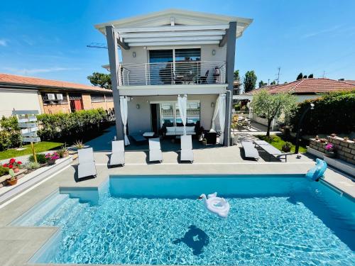 a house with a swimming pool in front of a house at A casa di Sabina in Desenzano del Garda