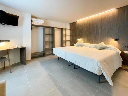 Ένα ή περισσότερα κρεβάτια σε δωμάτιο στο Hotel Quatre Llunes