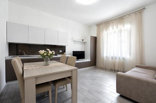 a kitchen and living room with a table and a couch at Giselle Apartments Maiori - Amalfi Coast in Maiori