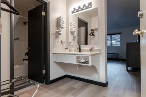 a bathroom with a sink and a mirror at The Scout INN in Cody