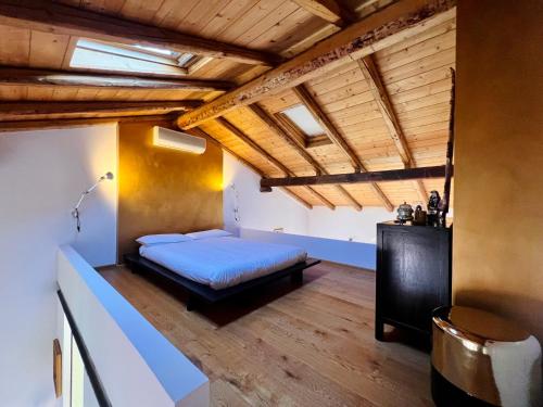 a bedroom with a bed in a room with wooden ceilings at House of Alchemy in Bologna