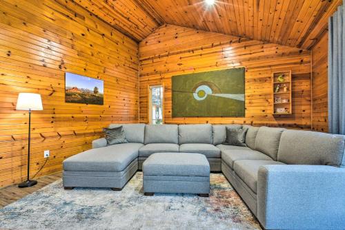 a living room with a couch and a table at Lakefront Applegate Retreat with Private Beach! in Applegate