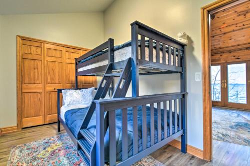 a blue bunk bed in a room with a window at Lakefront Applegate Retreat with Private Beach! in Applegate