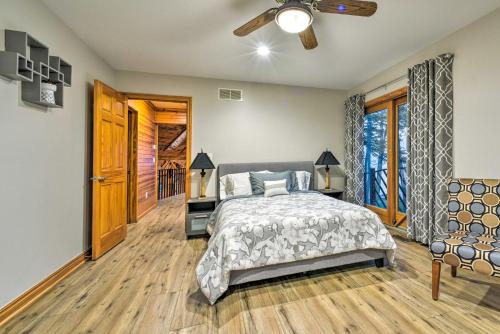 a bedroom with a bed and a ceiling fan at Lakefront Applegate Retreat with Private Beach! in Applegate