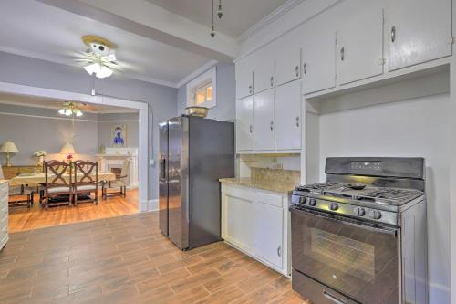a kitchen with a stove and a dining room at Spacious Lanett Haven with Sunroom and Large Deck in Lanett