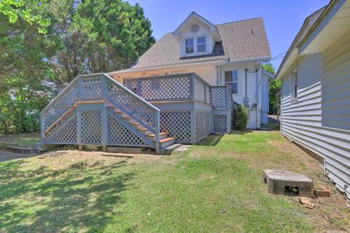 a house with a large deck in the yard at Spacious Lanett Haven with Sunroom and Large Deck in Lanett