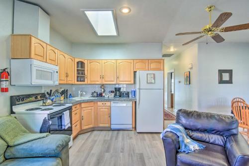 a kitchen with wooden cabinets and a white refrigerator at Rejuvenating Retreat with Ideal Eloy Location! in Eloy