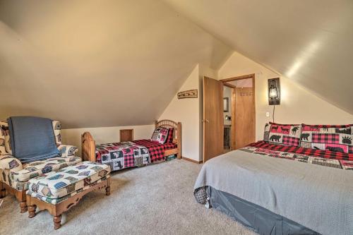 a bedroom with a bed and a couch and a chair at Family Cottage 3 Mi to Higgins Lake State Pk! in Roscommon