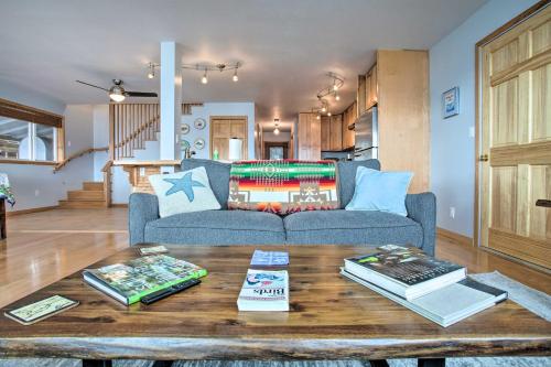 a living room with a couch and a table with books at Remote Island Escape with Breathtaking Views in Tenakee Springs