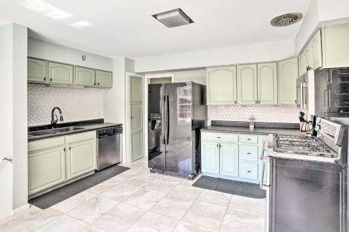 a kitchen with white cabinets and stainless steel appliances at Spacious Getaway with Heated Private Pool! in Michigan City