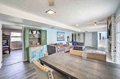 a living room with a table and a couch at Spacious Getaway with Heated Private Pool! in Michigan City