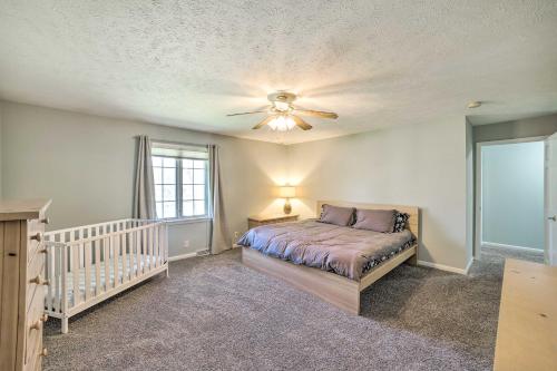 a bedroom with a bed and a ceiling fan at Spacious Getaway with Heated Private Pool! in Michigan City