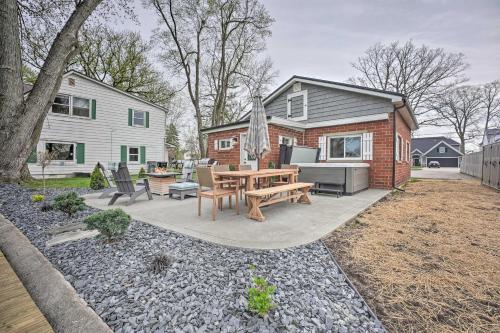 a backyard with a picnic table and a house at Waterfront Syracuse Home with Patio and Fire Pit! in Syracuse