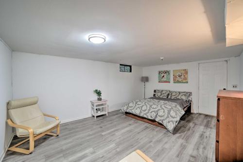 a bedroom with a bed and a chair at Spacious Getaway with Heated Private Pool! in Michigan City