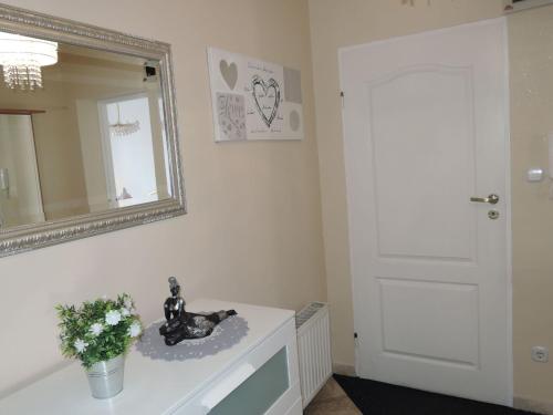 a bathroom with a mirror and a white door at Comfortable Appartment in centre of Miedzyzdroje for 4 persons in Międzyzdroje